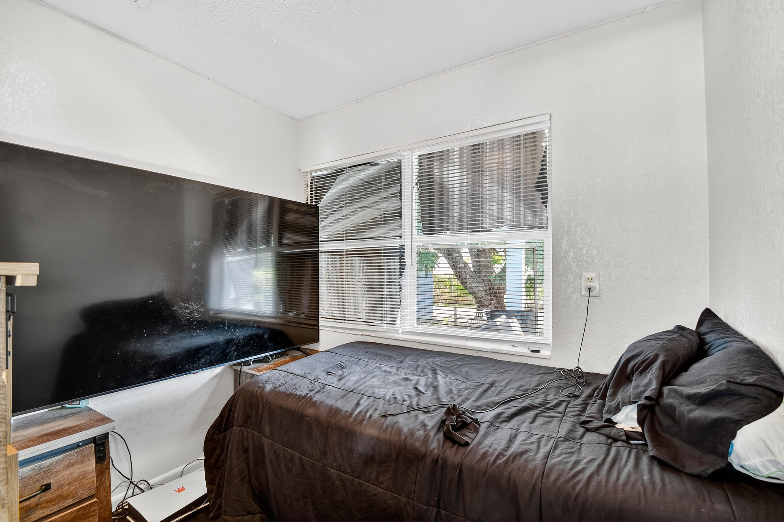 173 West 18th Street Riviera Beach, FL 33404 - Photo 13 of 28 a bedroom with a bed and wooden floor