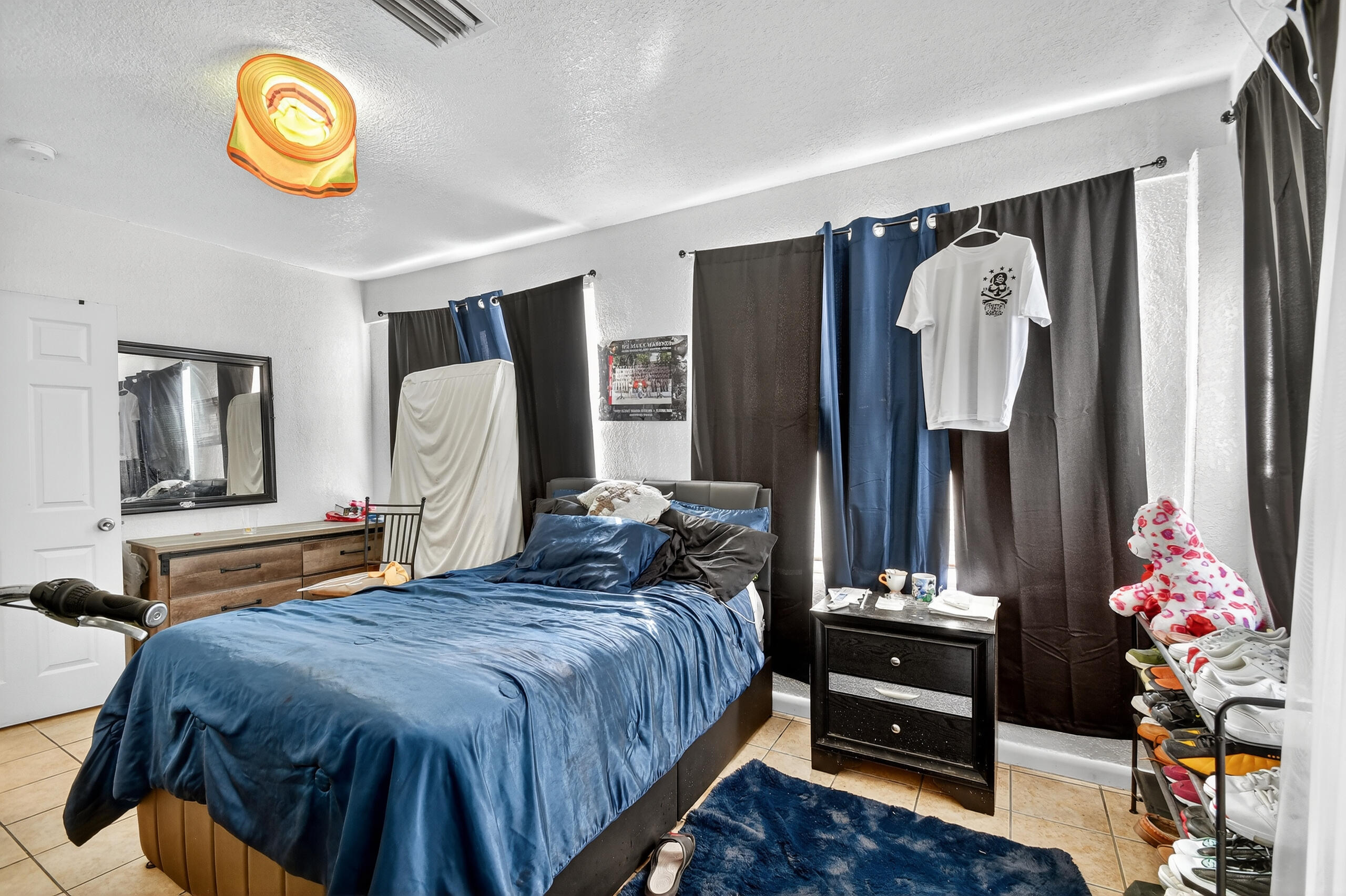 173 West 18th Street Riviera Beach, FL 33404 - Photo 14 of 28 a bedroom with bed and a mirror