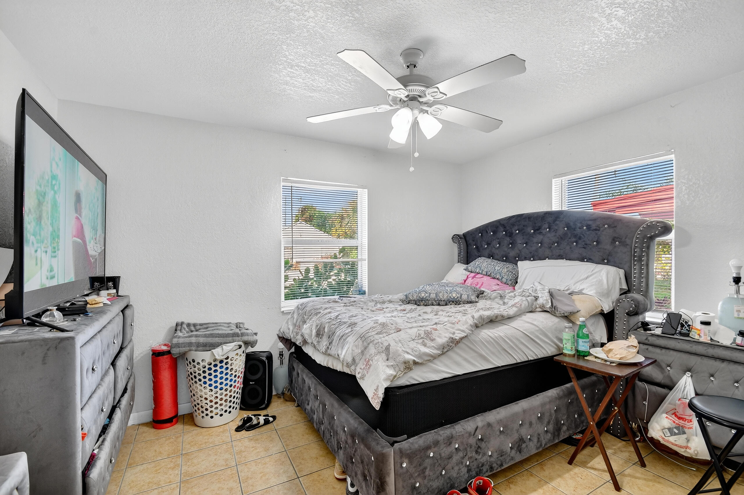 173 West 18th Street Riviera Beach, FL 33404 - Photo 17 of 28 a bedroom with a bed and a chandelier