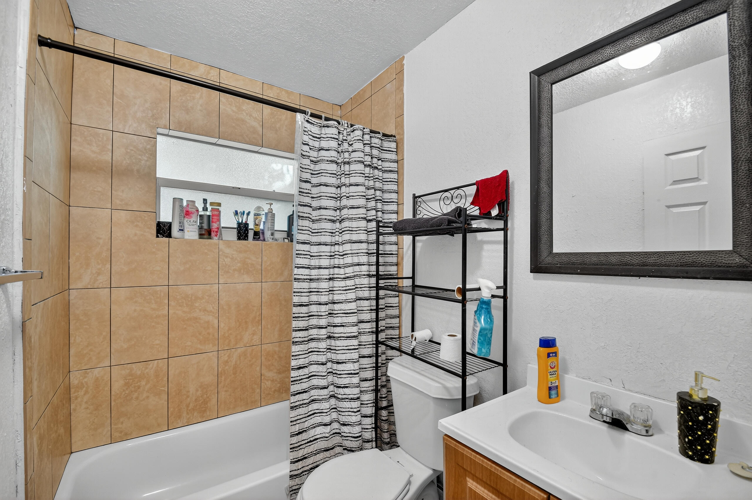 173 West 18th Street Riviera Beach, FL 33404 - Photo 18 of 28 a bathroom with a sink toilet and shower