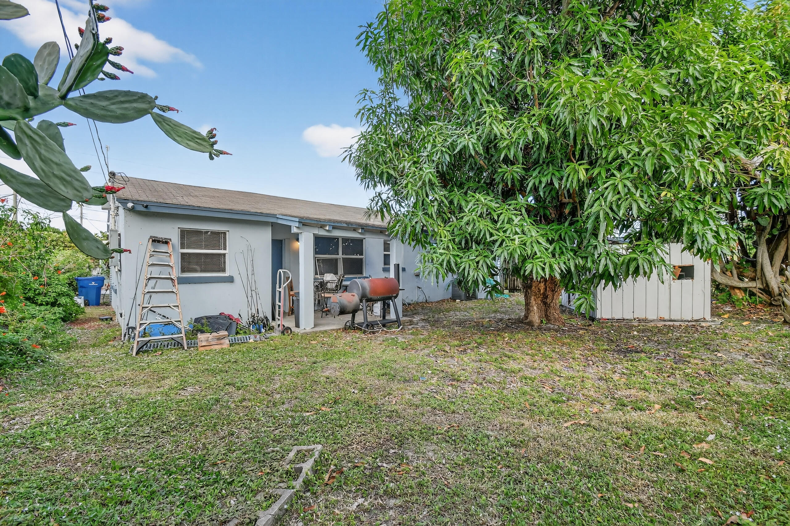 173 West 18th Street Riviera Beach, FL 33404 - Photo 21 of 28 a view of a house with a yard