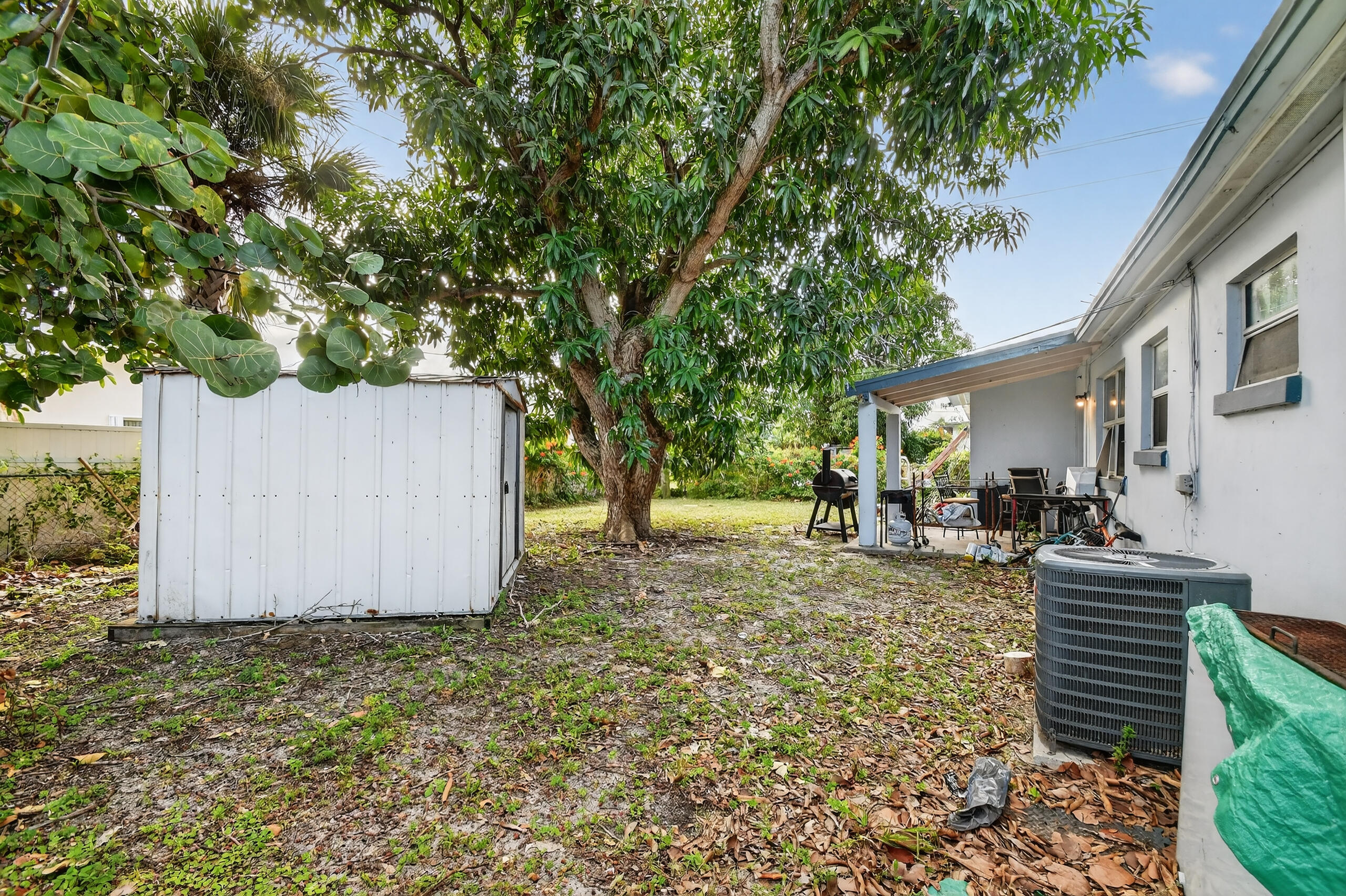 173 West 18th Street Riviera Beach, FL 33404 - Photo 23 of 28 a view of a house with backyard and sitting area
