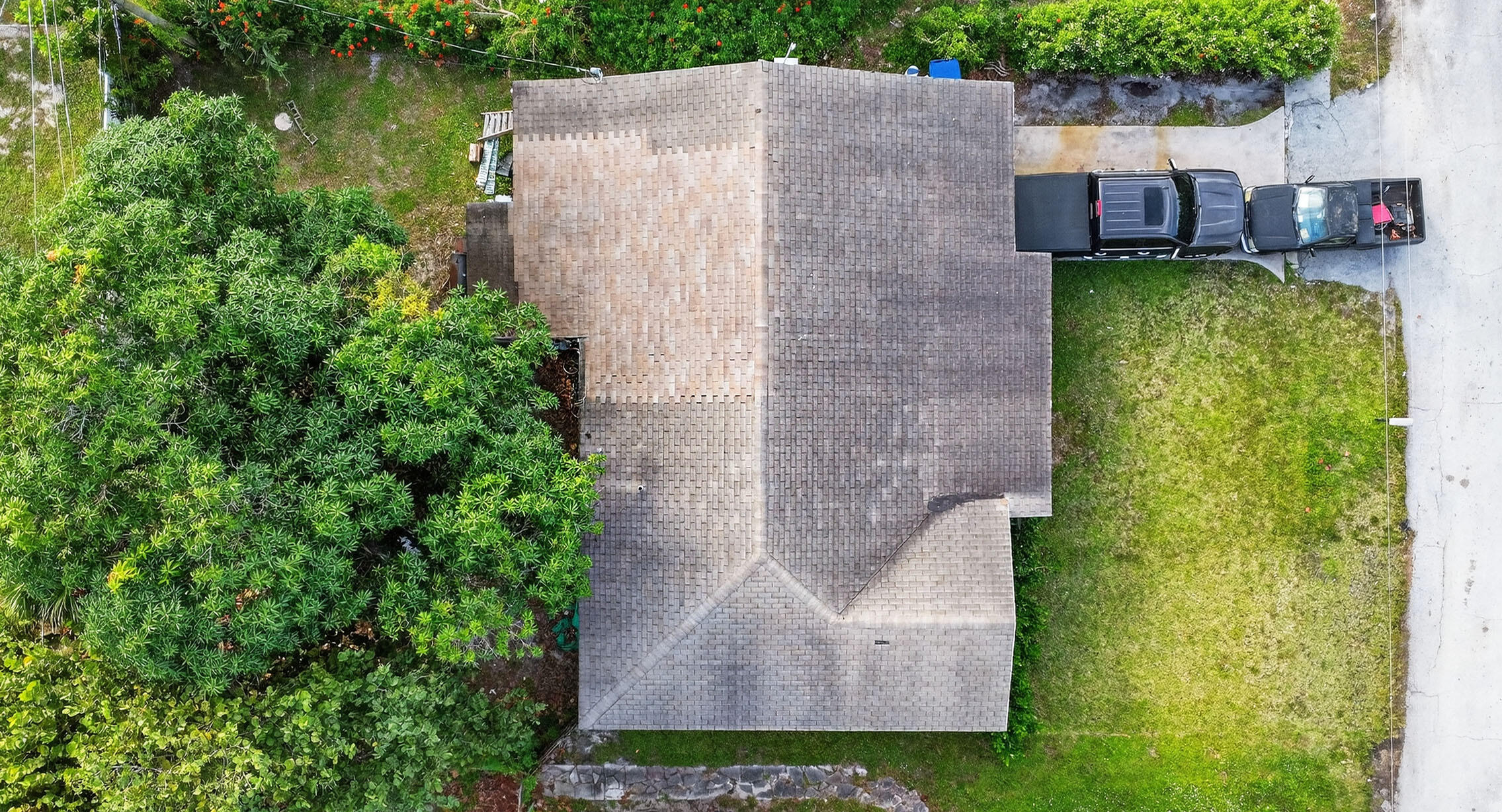 173 West 18th Street Riviera Beach, FL 33404 - Photo 25 of 28 an aerial view of a house with a yard and large trees