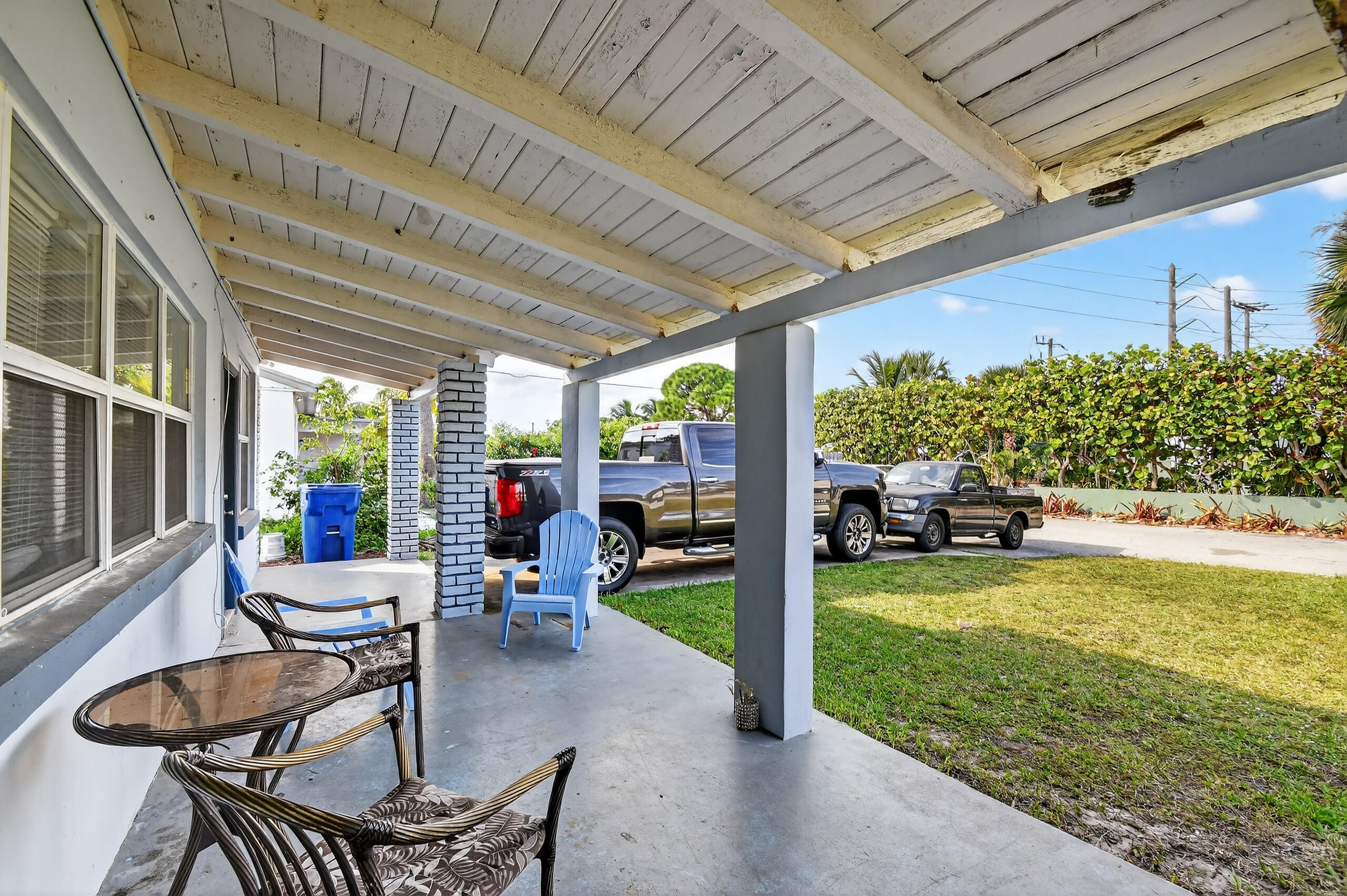 173 West 18th Street Riviera Beach, FL 33404 - Photo 5 of 28 a view of a patio with table and chairs and potted plants