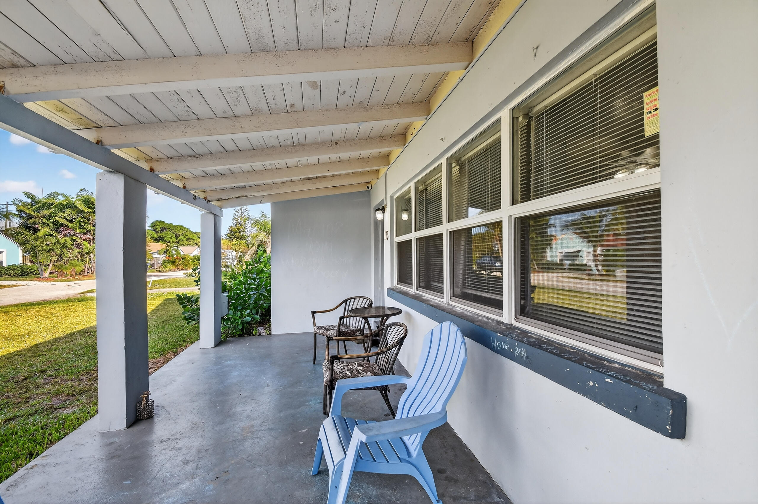 173 West 18th Street Riviera Beach, FL 33404 - Photo 6 of 28 a balcony with furniture and a floor to ceiling window