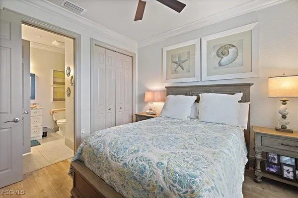 a bedroom with a bed and a lamp on dresser