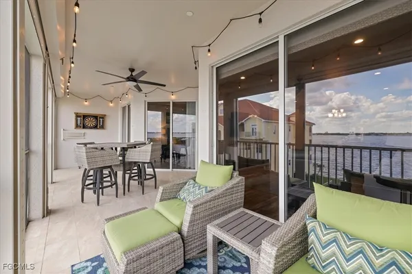 a living room with furniture a rug and a floor to ceiling window