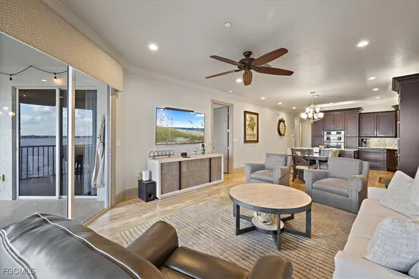 a living room with furniture and a dining table with kitchen view