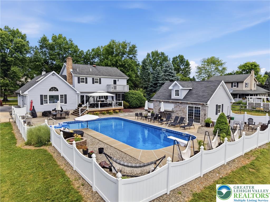 890 Lahr Road Nazareth, PA 18064 - Photo 44 of 71 An inviting backyard oasis offers a sparkling pool and multiple outdoor entertaining spaces.