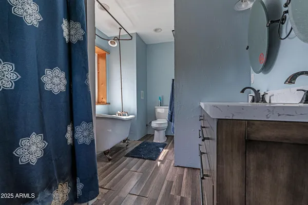 a bathroom with a sink a toilet and a mirror