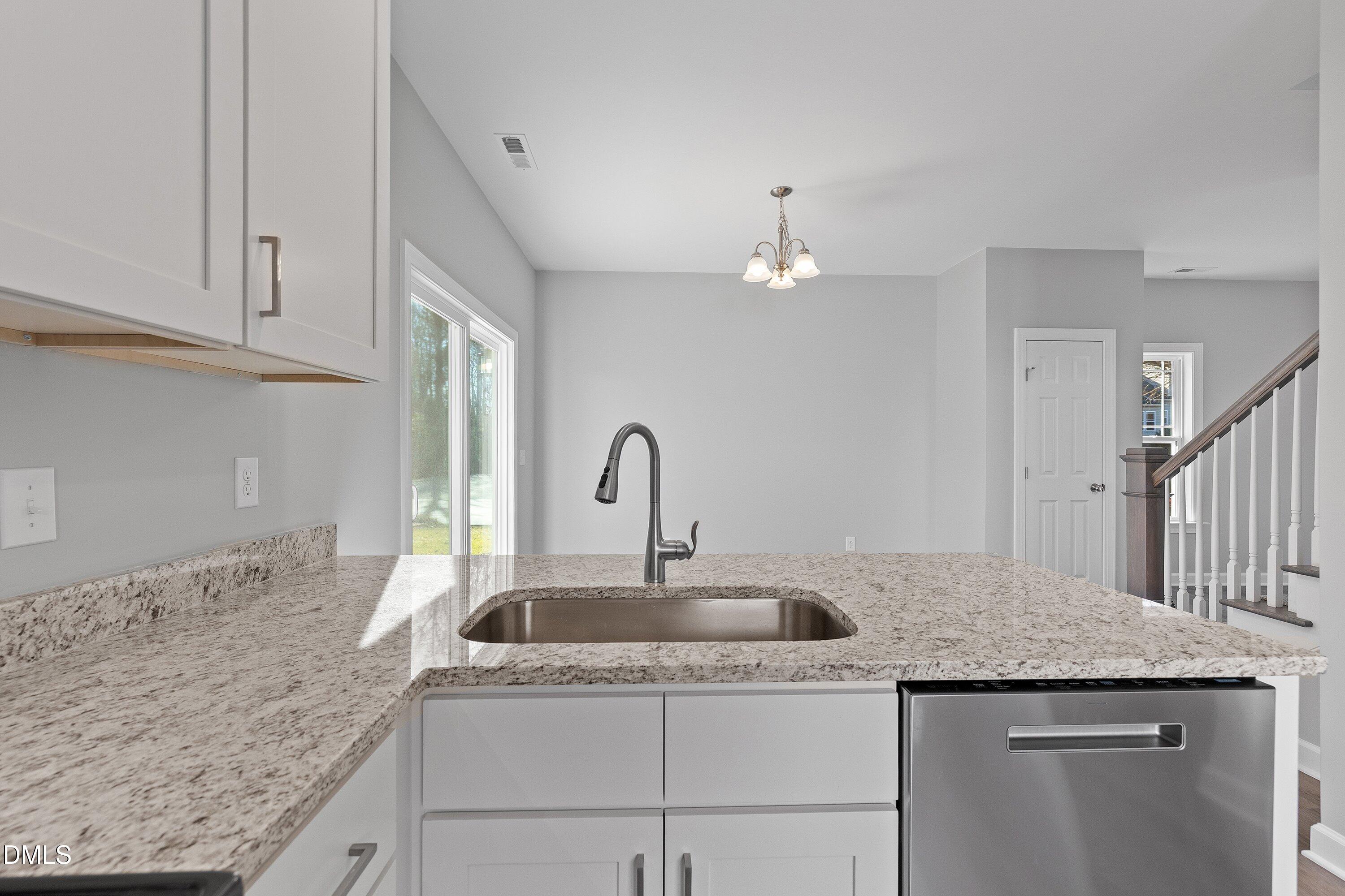 1804 Falls Landing Drive Raleigh, NC 27614 - Photo 14 of 20 a kitchen with granite countertop a sink and cabinets