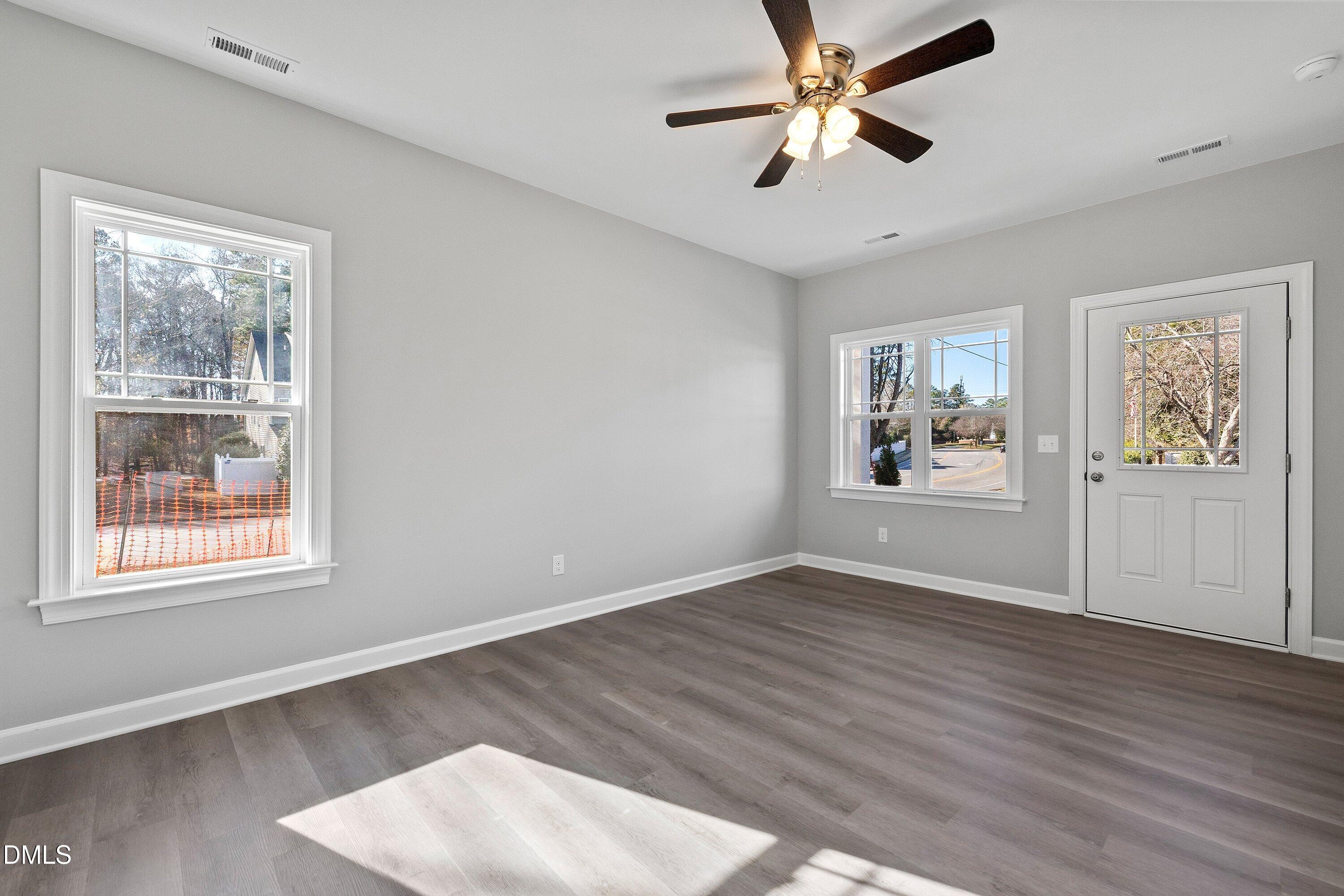 1804 Falls Landing Drive Raleigh, NC 27614 - Photo 5 of 20 a view of an empty room with window and wooden floor