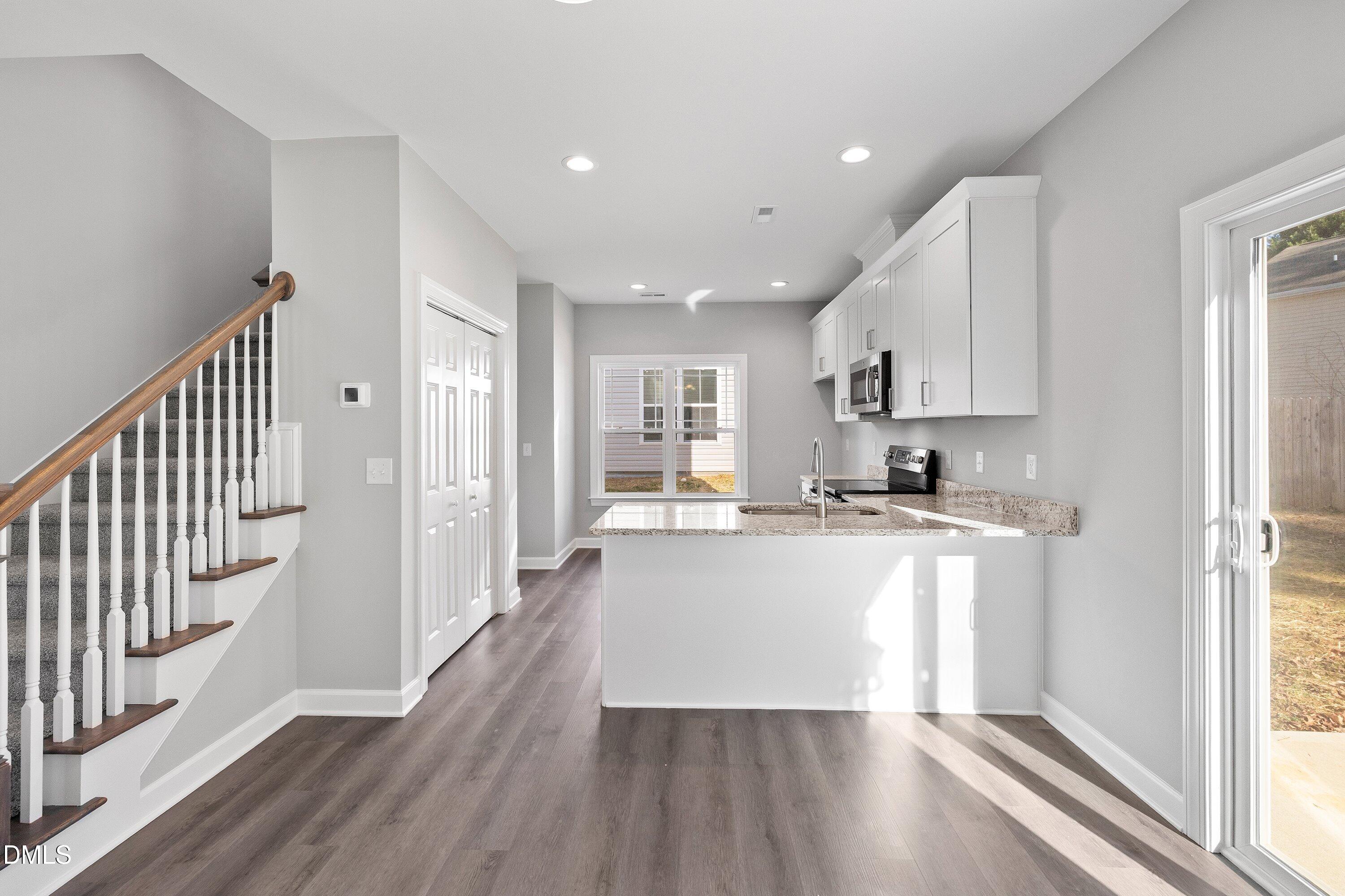 1804 Falls Landing Drive Raleigh, NC 27614 - Photo 10 of 20 a kitchen with refrigerator and wooden floor