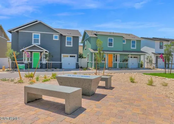 a view of an house with swimming pool and chairs