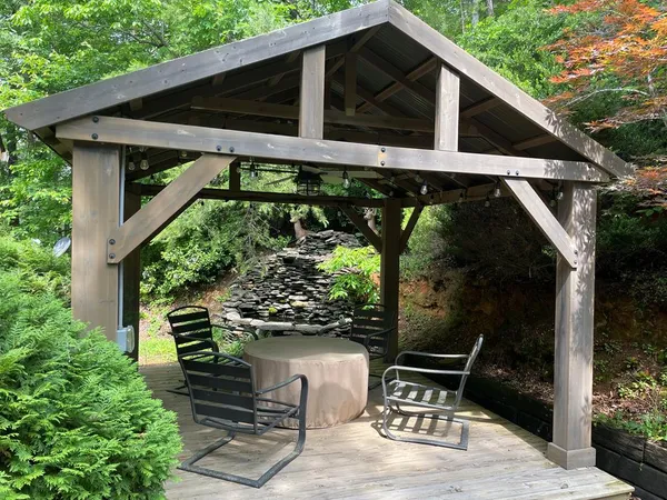 a roof deck with table and chairs potted plants with wooden floor