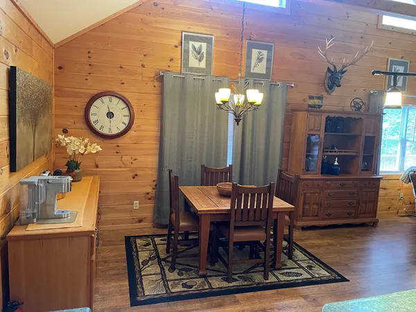 a view of a room with furniture and wooden floor