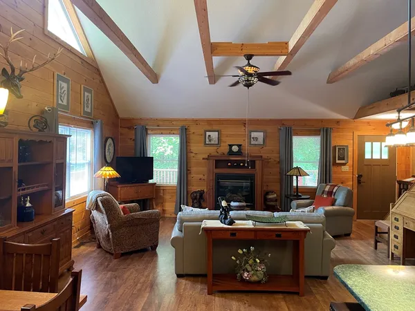 a living room with furniture a fireplace and a flat screen tv