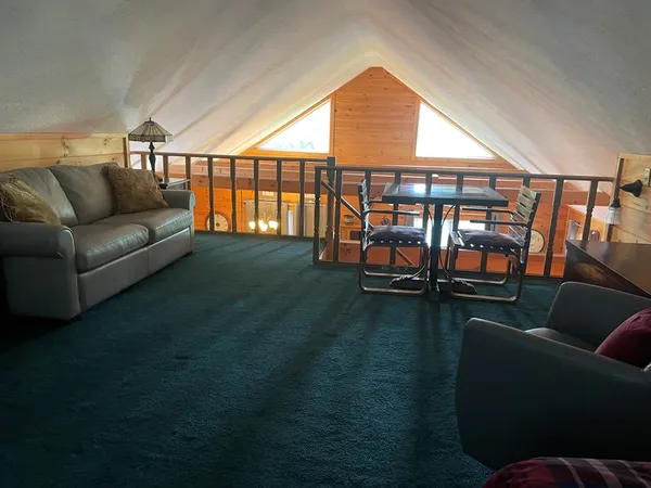 a living room with furniture and a floor to ceiling window