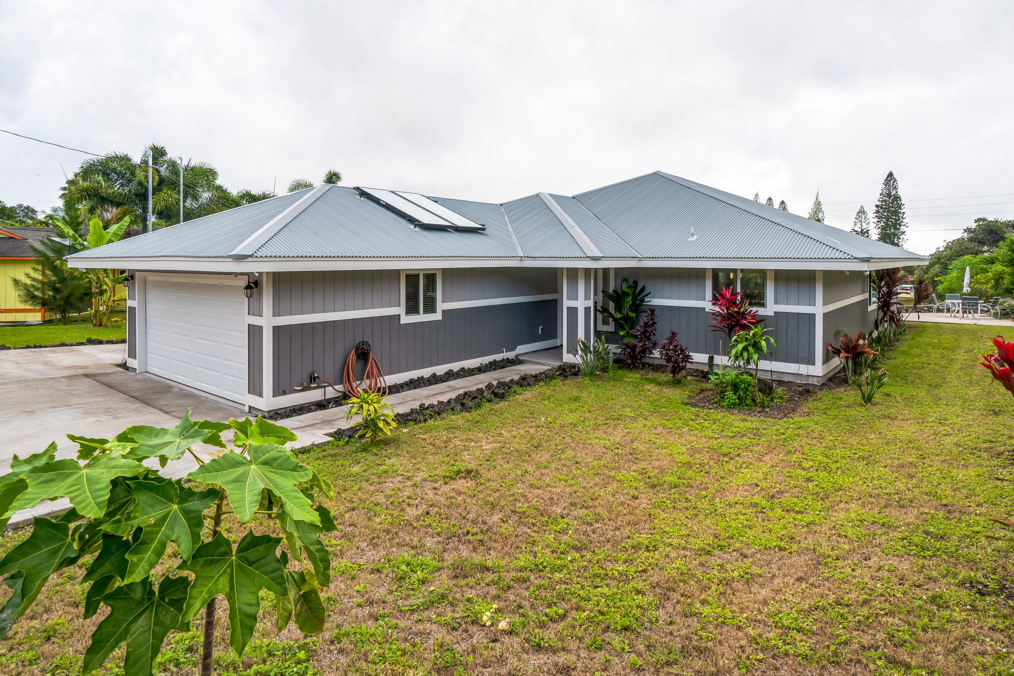 a view of a house with a yard and sitting area