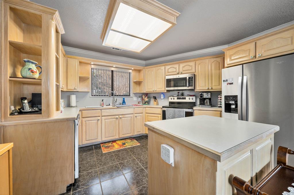 24008 Oak Shadow Whitney, TX 76692 - Photo 11 of 38 a kitchen with stainless steel appliances a refrigerator sink and microwave