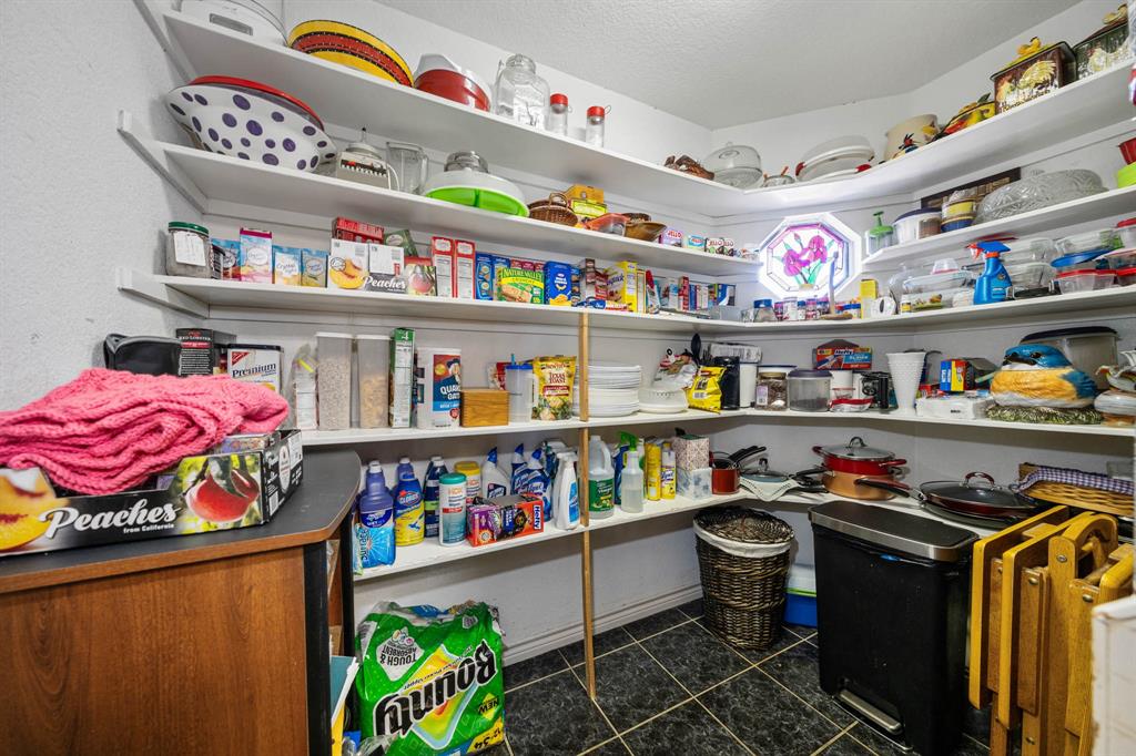 24008 Oak Shadow Whitney, TX 76692 - Photo 12 of 38 a utility room with lots of clutter and cabinets