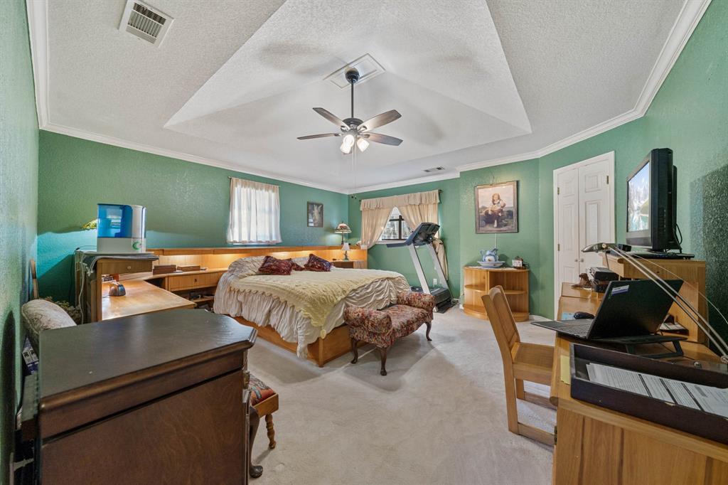 24008 Oak Shadow Whitney, TX 76692 - Photo 13 of 38 a bedroom with a bed gym equipment and a large window