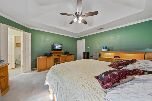 a bedroom with a bed and a chandelier