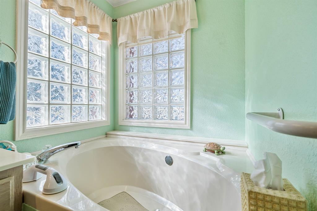 24008 Oak Shadow Whitney, TX 76692 - Photo 16 of 38 a bath tub sitting in a bathroom next to a window