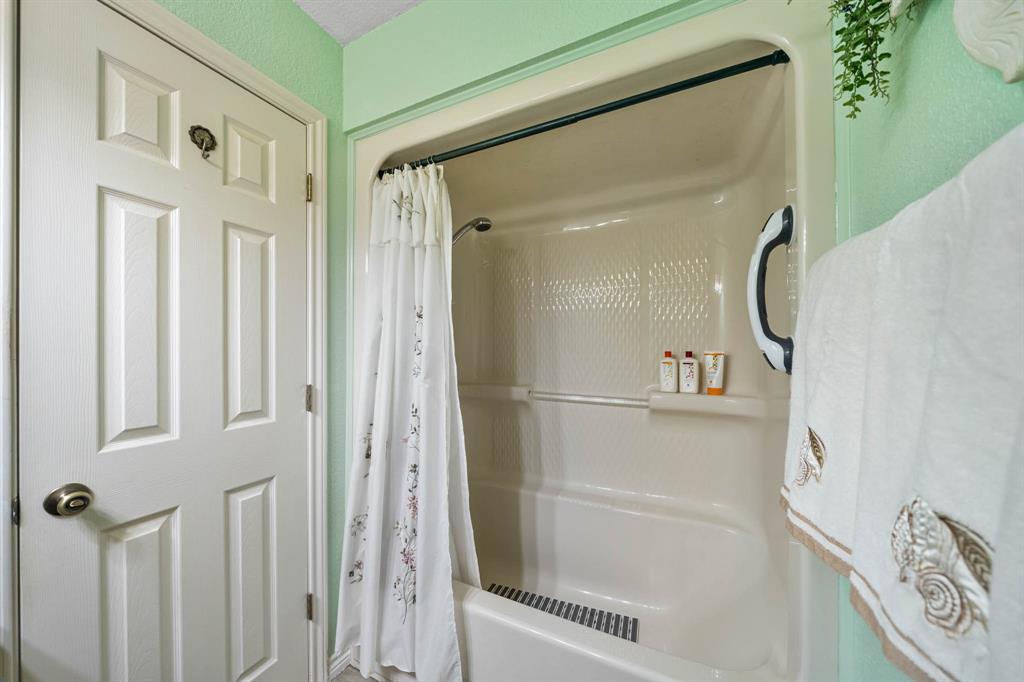 24008 Oak Shadow Whitney, TX 76692 - Photo 23 of 38 a bathroom with a glass shower door