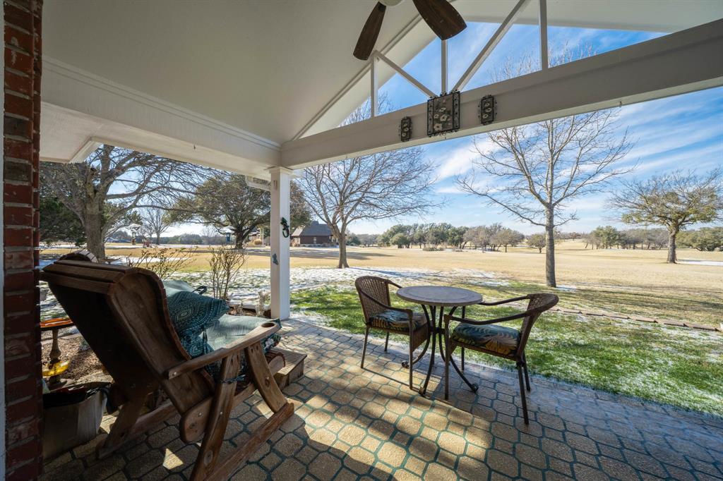 24008 Oak Shadow Whitney, TX 76692 - Photo 30 of 38 a view of a patio with table and chairs next to a yard