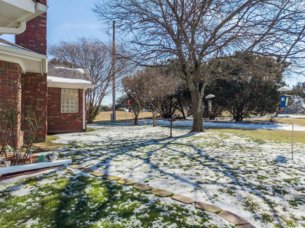 24008 Oak Shadow Whitney, TX 76692 - Photo 31 of 38 a house with trees in front of it