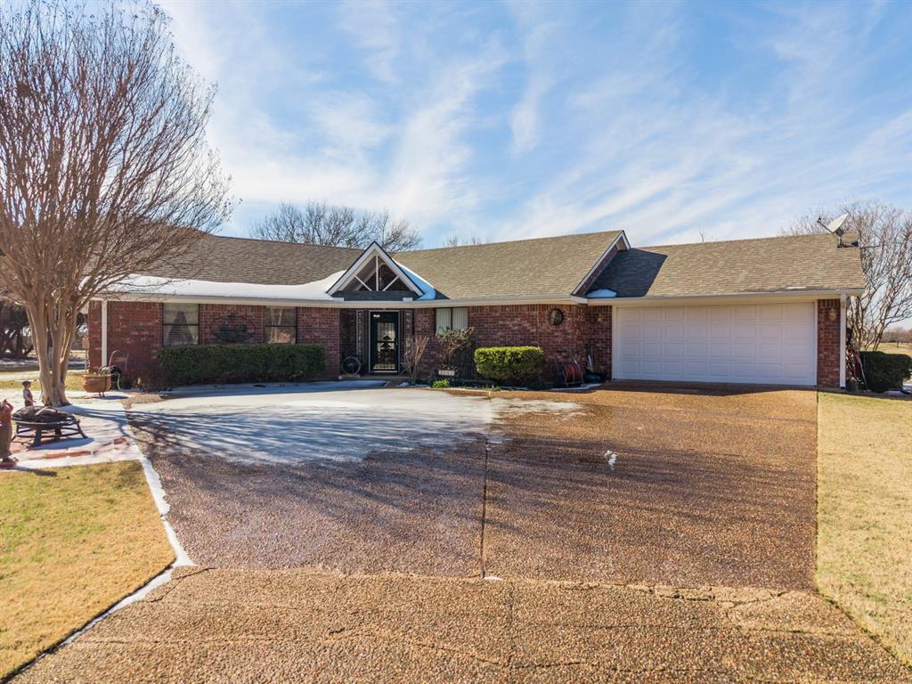 24008 Oak Shadow Whitney, TX 76692 - Photo 38 of 38 a front view of a house with a yard and garage