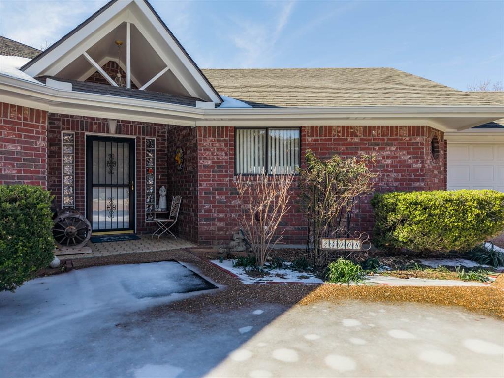 24008 Oak Shadow Whitney, TX 76692 - Photo 4 of 38 a front view of a house with a garden