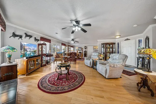 a living room with furniture kitchen view and a table