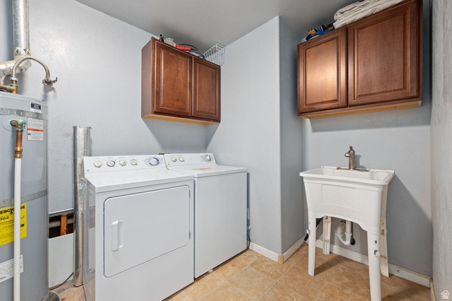 348 North Lodge Road Central, UT 84722 - Photo 11 of 25 Laundry room featuring secured water heater, cabinet space, washing machine and dryer, and light tile patterned floors