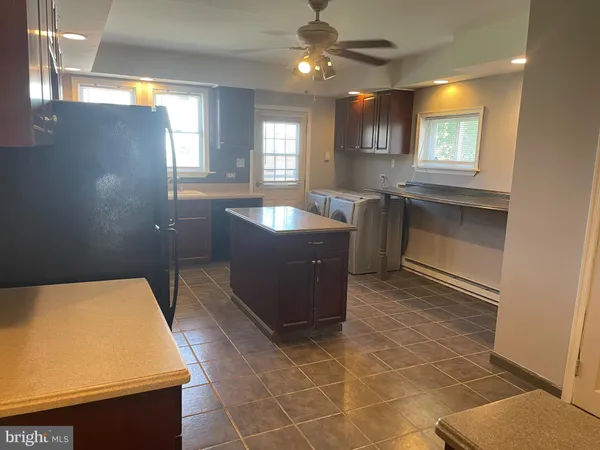 a room with pool table and windows