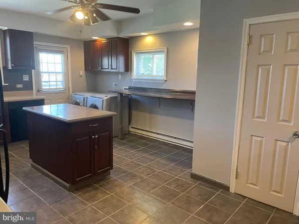 a kitchen with a sink a counter space and a window