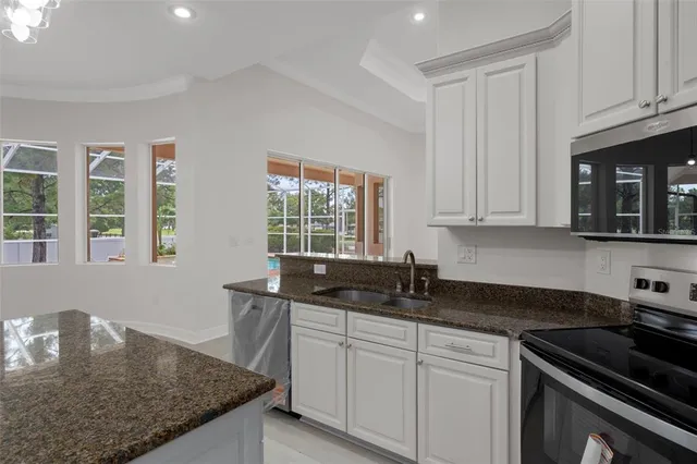 a bathroom with a granite countertop sink a toilet a mirror and shower