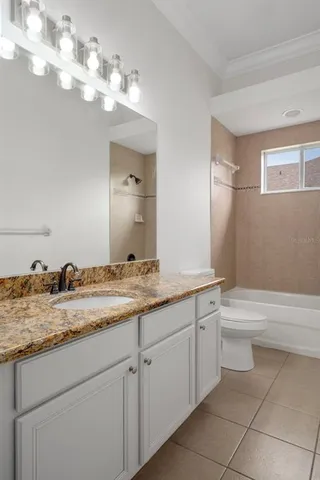 a living room with furniture and white couches with garden view