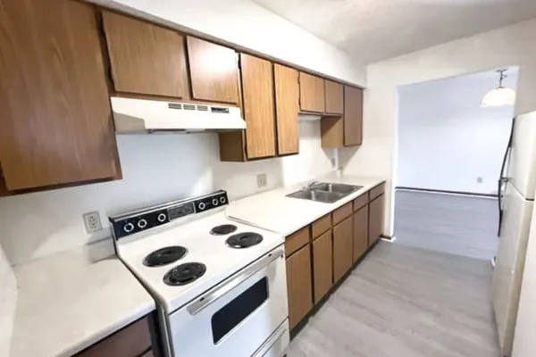a kitchen with stainless steel appliances a refrigerator stove and sink