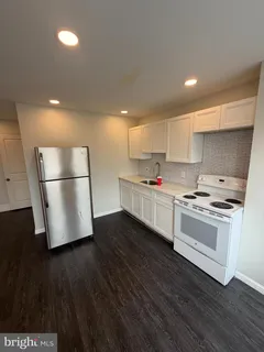 a kitchen with stainless steel appliances granite countertop a refrigerator a stove a sink dishwasher and a refrigerator