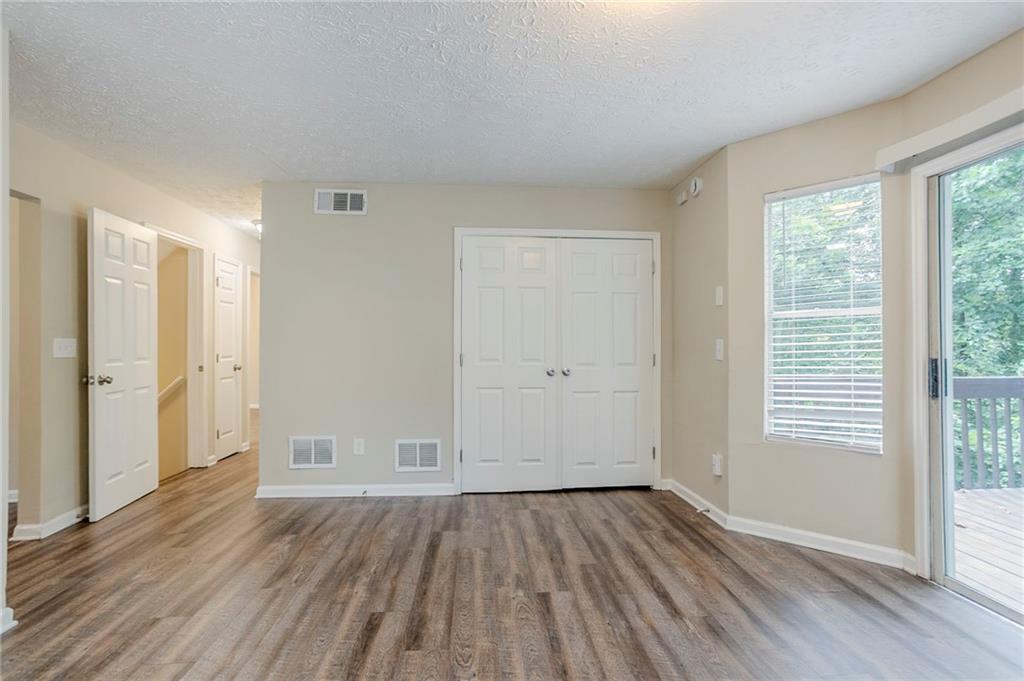 3822 Conley Downs Lane Decatur, GA 30034 - Photo 14 of 46 an empty room with wooden floor and windows