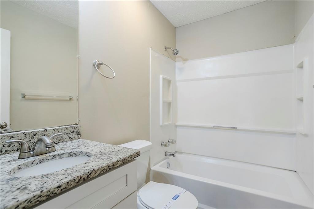 3822 Conley Downs Lane Decatur, GA 30034 - Photo 30 of 46 a bathroom with a granite countertop sink toilet and shower