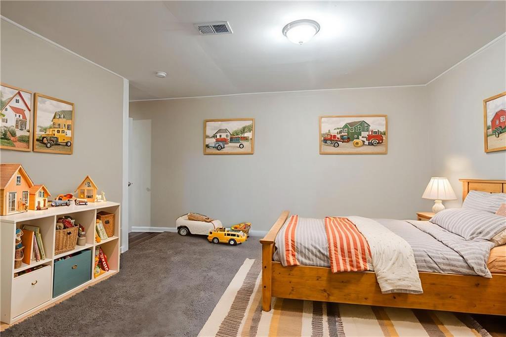 3822 Conley Downs Lane Decatur, GA 30034 - Photo 6 of 46 a bedroom with a bed and a book shelf