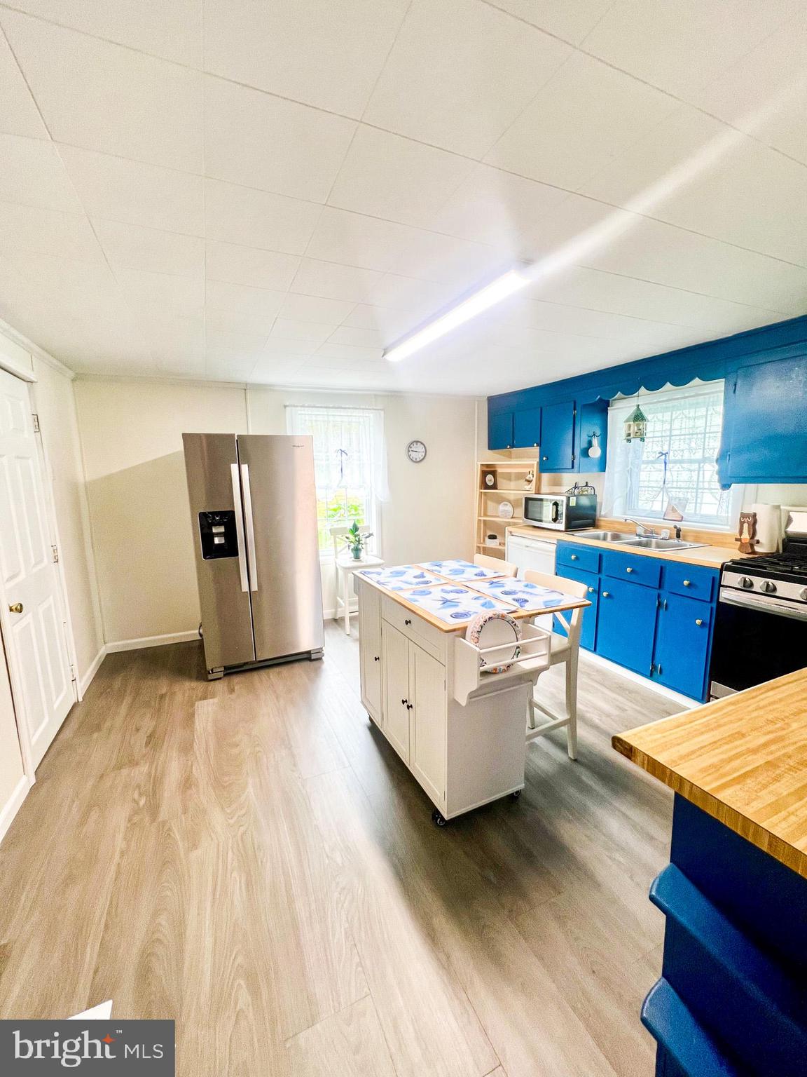 413 Walker Street Osceola Mills, PA 16666 - Photo 13 of 26 a large living room with stainless steel appliances kitchen island granite countertop a sink wooden floor and cabinets