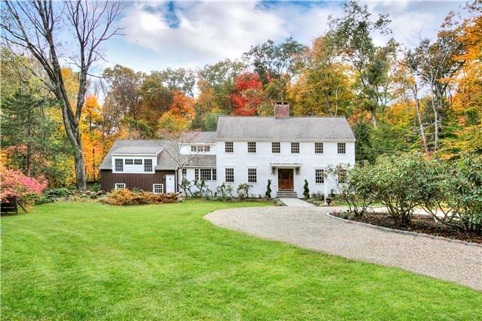 9 Beechwood Lane Ridgefield, CT 06877 - Photo 1 of 1 a view of a white house in front of a big yard with plants and large trees