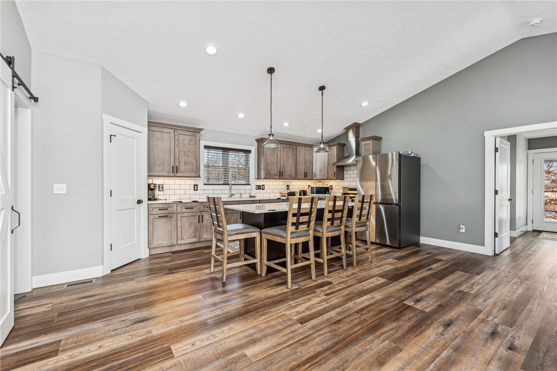 1602 Westboro Road Blanchester, OH 45107 - Photo 29 of 81 This spacious kitchen features sleek appliances, a large island, and durable wood flooring.