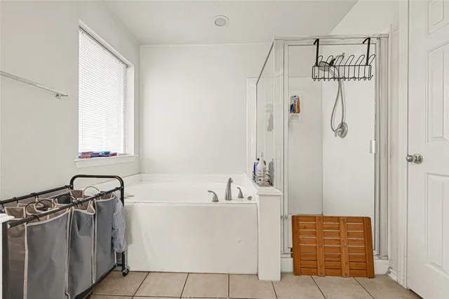 a bathroom with a shower a sink and a mirror
