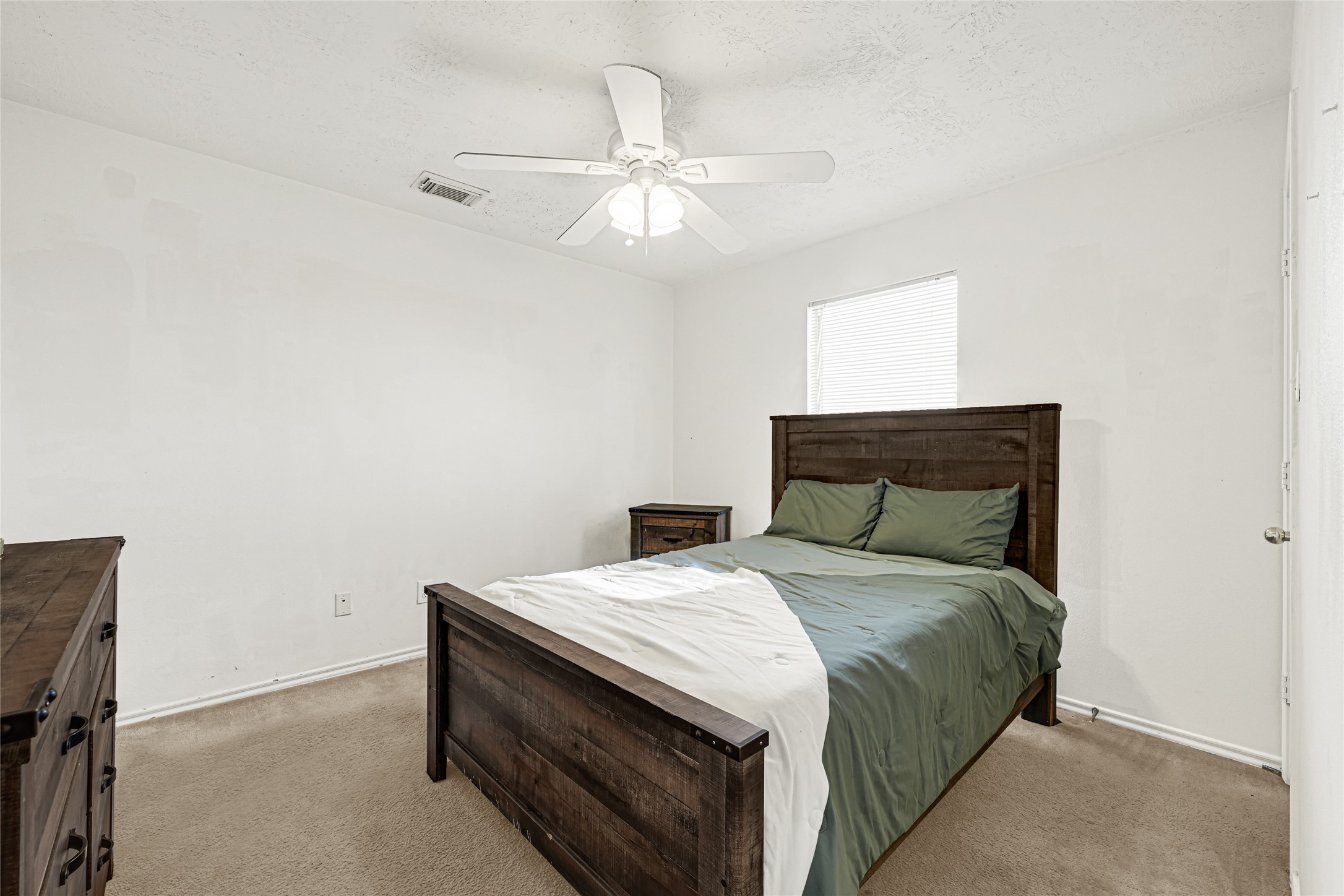 5707 Meadow Breeze Lane Rosharon, TX 77583 - Photo 20 of 26 a bedroom with a bed and a chandelier fan