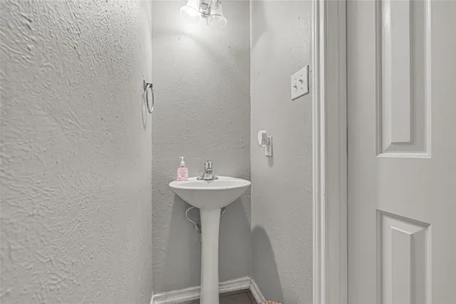 a small bathroom with a sink and mirror